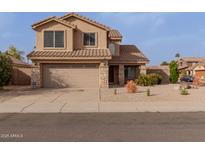 Inviting two-story home featuring a well-manicured front yard and a two-car garage at 3234 E Marco Polo Rd, Phoenix, AZ 85050