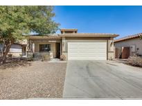 Charming single-story home featuring a well-manicured front yard and an attached two-car garage at 328 W Dragon Tree Ave, San Tan Valley, AZ 85140