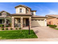 Charming two-story home with stone accents, manicured lawn, and inviting curb appeal at 3522 E Spring Wheat Ln, Gilbert, AZ 85296