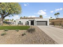 Stunning home featuring a modern design, xeriscaping, and an attached two-car garage at 5202 E Marconi Ave, Scottsdale, AZ 85254