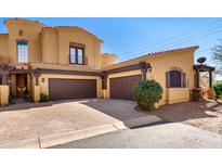 Stunning two-story stucco home boasts a three-car garage and a charming tile roof under a beautiful blue sky at 5370 S Desert Dawn Dr # 39, Gold Canyon, AZ 85118
