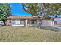 Charming single-story home with stone accents and well-maintained lawn at 7044 W Sierra St, Peoria, AZ 85345