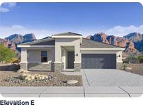 Charming single-story home featuring a two-car garage and a desert landscape against a backdrop of mountains at 10035 S 23Rd Dr, Phoenix, AZ 85041