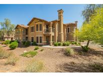 Stunning two-story townhouse with a desert landscape, a chimney, and a small upper balcony at 14250 W Wigwam Blvd # 812, Litchfield Park, AZ 85340