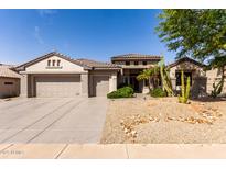 Attractive single-story home featuring a three-car garage and low-maintenance desert landscaping at 18140 N Saddle Ridge Dr, Surprise, AZ 85374