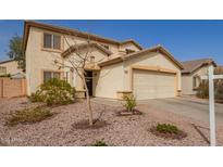 Inviting two-story home featuring a two-car garage and desert landscaping at 22644 W Mohave St, Buckeye, AZ 85326