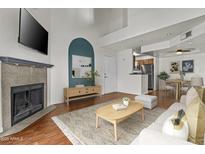 Bright living room featuring a fireplace, television, and dining area, great for relaxing and entertaining at 3845 E Greenway Rd # 230, Phoenix, AZ 85032