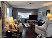 Comfortable living room features modern décor, a large TV, and lots of natural light at 44 S Hawes Rd # B7, Mesa, AZ 85208
