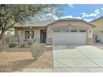 Inviting single-story home with a two-car garage and low-maintenance desert landscaping at 4613 W Ellis St, Laveen, AZ 85339