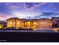 Charming single-Gathering home showcasing a well-manicured front yard and inviting curb appeal at dusk at 6130 E Bramble Berry Ln, Cave Creek, AZ 85331