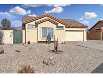 Charming single-story home featuring desert landscaping and an attached two-car garage at 8900 E Rainier Dr, Gold Canyon, AZ 85118
