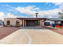 Single-story home with covered parking, desert landscaping, and charming arched windows at 1219 W Galveston St, Chandler, AZ 85224