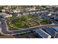 An aerial view of a neighborhood featuring a beautiful green park with a playground, walking trails, and picnic spots at 2330 E Lieber Pl, Phoenix, AZ 85024