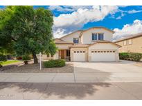 Charming two-story home with a three car garage, desert landscaping, and a mature shade tree in the front yard at 2551 E Buena Vista Pl, Chandler, AZ 85249
