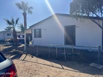 Charming single-story home featuring a fenced yard, desert landscaping, and a welcoming entryway at 420 S 98Th Way, Mesa, AZ 85208