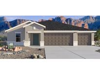 Charming single-story home with a three-car garage, desert landscaping, and mountain views at 5694 E Axle Ln, San Tan Valley, AZ 85140