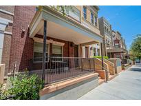 Charming brick townhouse with a covered front porch and seating area perfect for relaxing outdoors at 578 W 6Th St, Tempe, AZ 85281