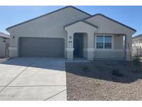 Charming single-story home featuring a neutral stucco exterior, a two-car garage, and a well-manicured, low-maintenance front yard at 631 W Freedom St, Florence, AZ 85132