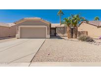 Charming single-story home featuring desert landscaping, a two-car garage, and a welcoming entrance at 6460 S Springs Pl, Chandler, AZ 85249