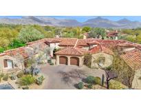 Stunning aerial view of home with mountain views, tile roof, desert landscaping, and private two car garage at 8965 E Mountain Spring Rd, Scottsdale, AZ 85255