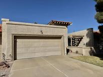 Charming home featuring attached two-car garage and concrete driveway, perfect for parking and curb appeal at 10224 E Minnesota Ave, Sun Lakes, AZ 85248