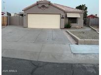 Charming single-story home with a two-car garage and a low maintenance yard at 15659 W Ripple Cir, Goodyear, AZ 85338