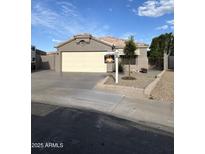 Charming single-story home with a well-maintained front yard and a two-car garage at 15659 W Ripple Cir, Goodyear, AZ 85338