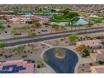 Beautiful aerial view of community amenities including a pool, spa, tennis courts, and desert landscaping at 15848 W Lahlum Ln, Surprise, AZ 85374