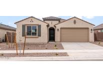 Charming single-story home with a stucco exterior, desert landscaping, and attached two-car garage at 16721 W Whispering Wind Dr, Surprise, AZ 85387