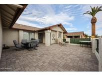 Expansive outdoor patio, perfect for entertaining, with a dining table and lounge chairs at 1699 Leisure World --, Mesa, AZ 85206