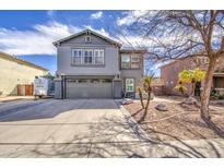 Charming two-story home with gray stucco, a two-car garage, and desert landscaping in the front yard at 2607 W Ironstone Ave, Apache Junction, AZ 85120