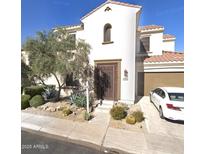 Charming two-story home with a tile roof, desert landscaping, and an attached two-car garage at 280 W Wisteria Pl, Chandler, AZ 85248