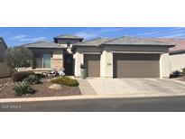 Charming single-story home with a well-manicured front yard and three-car garage in a desirable community at 3074 N 167Th Dr, Goodyear, AZ 85395