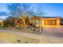 Charming single-story home featuring a desert landscape and an attached two-car garage at 32742 N 15Th Gln, Phoenix, AZ 85085