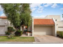 Charming home featuring a terra cotta tile roof, a two-car garage and mature desert landscaping at 5139 N 76Th Pl, Scottsdale, AZ 85250