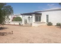 Charming white home featuring a gated courtyard with a pergola for shaded enjoyment at 6010 E Mountain View Rd, Paradise Valley, AZ 85253
