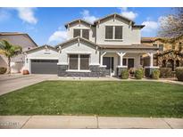 Inviting two-story home boasts a manicured lawn and a convenient two-car garage at 9712 E Tangerine Rd, Florence, AZ 85132