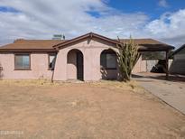 Exterior of a cozy single-story home with a desert landscape and arched entryway at 3452 E Evans Dr, Phoenix, AZ 85032