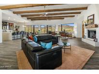 Bright living room boasts wood-beamed ceilings, modern furnishings, and picturesque mountain views at 36102 N Creek View Ln, Cave Creek, AZ 85331