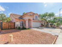 Charming two-story home featuring a well-manicured lawn, desert landscaping, and an attached two-car garage at 6219 W Navajo Dr, Glendale, AZ 85302