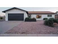 Charming single-story home featuring a two-car garage and desert landscaping at 8637 E Mulberry St, Scottsdale, AZ 85251