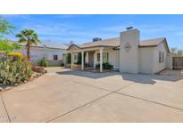 Charming single-story home with desert landscaping, neutral exterior, and a spacious front parking area at 901 E Hearn Rd, Phoenix, AZ 85022