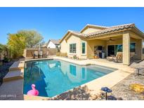 Inviting backyard pool with covered patio, perfect for outdoor entertaining and relaxation at 10817 W Swayback Pass, Peoria, AZ 85383