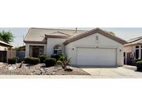 Charming single story home with a neutral color palette, two car garage, and desert landscaping at 11029 W Oraibi Dr, Peoria, AZ 85373