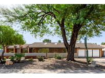 Charming single-story home featuring desert landscaping, modern architecture, and a private two-car garage at 1755 W Lawrence Ln, Phoenix, AZ 85021