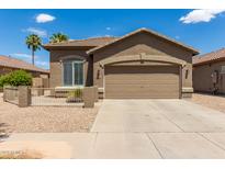 Charming single-story home featuring a two-car garage and desert landscaping at 20840 E Vía Del Palo --, Queen Creek, AZ 85142