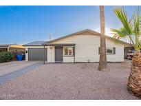 Charming single-story home with a well-manicured front yard and attached garage at 2301 E Alpine E Ave, Mesa, AZ 85204