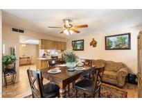 Inviting dining area featuring a wood table with seating for four, and a decorative floral arrangement at 2801 N Dakota St, Chandler, AZ 85225