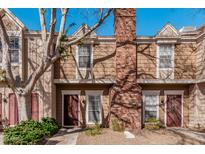 Inviting townhouse exterior with a red brick chimney and neat landscaping at 3334 W Morrow Dr # 3, Phoenix, AZ 85027