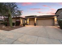 Inviting home featuring a spacious three-car garage and desert landscaping for low-maintenance appeal at 4411 E Spur Dr, Cave Creek, AZ 85331